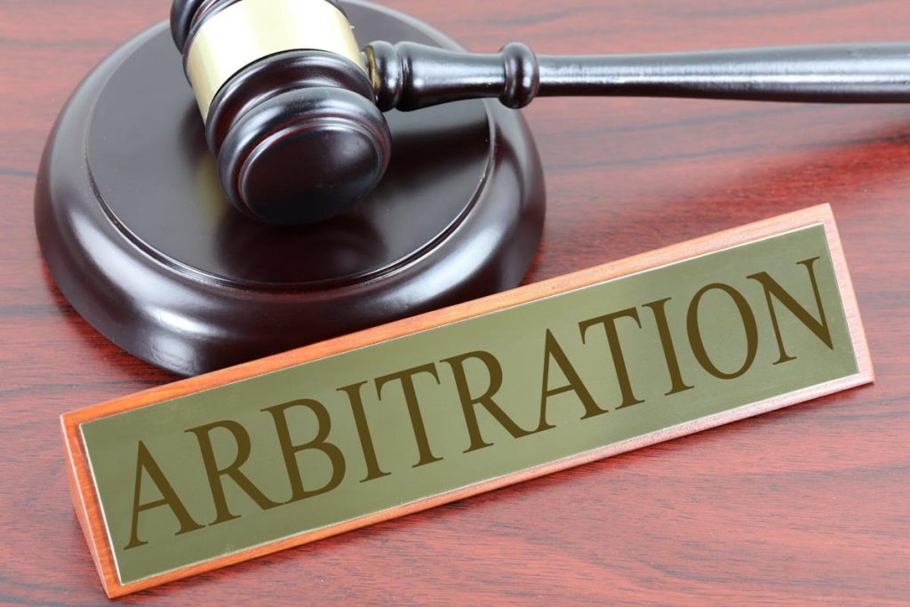 gavel and plaque that reads "arbitration"